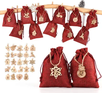 A collection of red burlap advent calendar bags with wooden ornaments hanging from a branch, and a separate display of wooden ornaments.