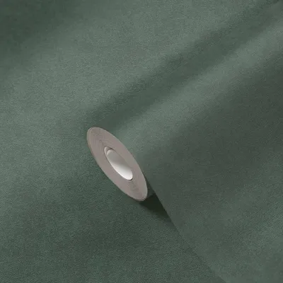 A roll of petrol green textured wallpaper is shown diagonally against a matching background.