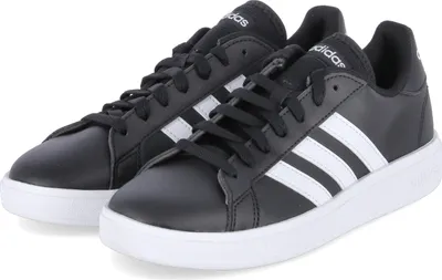 A pair of black Adidas sneakers with white stripes and soles, shown from a slightly elevated side angle.