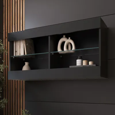 A black wall-mounted display cabinet with two shelves, showcasing books, decorative vases, and small containers.