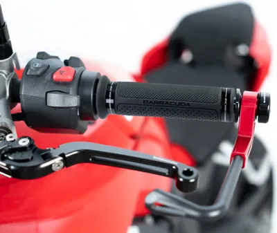Close-up of motorcycle handlebars with grips and levers.