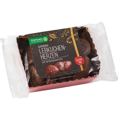 A package of gluten-free gingerbread hearts with dark chocolate coating.