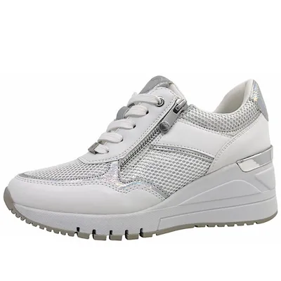 A side view of a white and silver women's sneaker.