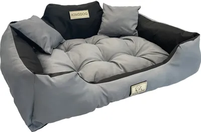 A dog bed with pillows, displayed against a white background.