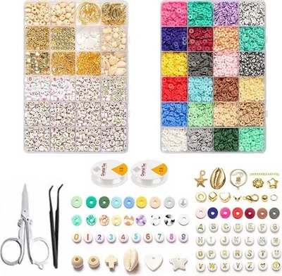 A flat lay image showing a large DIY jewelry making kit with many compartments filled with beads, charms, and tools.