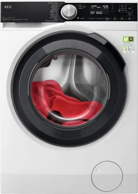 A front view of a white AEG washing machine with a red towel inside the drum.