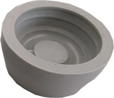 A close-up, angled view of a grey, bowl-shaped object with concentric ridges inside and a circular protrusion in the center.