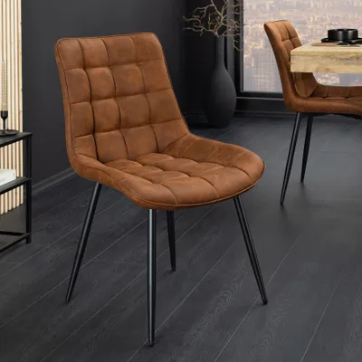 A brown upholstered dining chair with black metal legs is shown in a dining room setting.