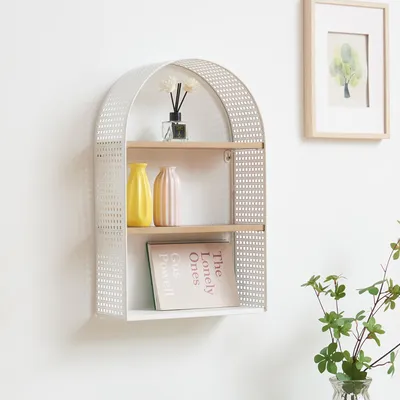 A white arched shelf with two wooden shelves mounted on a white wall. The shelf contains decorative items.