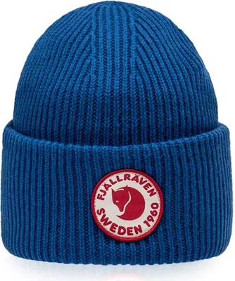 A blue knitted beanie with a circular red and white logo patch on the front.
