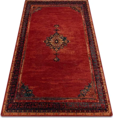 A red rug with a traditional pattern is shown from a high angle.