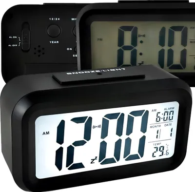 Three black digital alarm clocks are displayed, with the front clock showing the time 12:00.