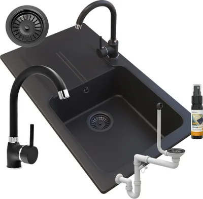 A black granite sink with two faucets, a drain assembly, and a spray bottle.