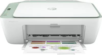 A white and green HP DeskJet 2722e printer is shown from the front with its paper output tray open and a document partially printed.
