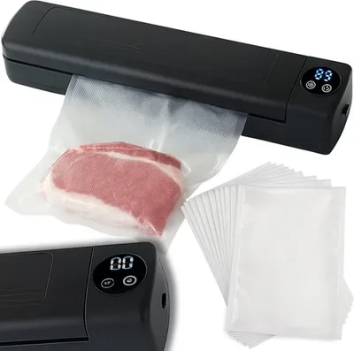 A black vacuum sealer machine is shown sealing a piece of meat in a plastic bag, with a stack of empty bags to the side.