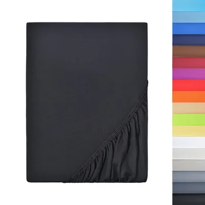 A dark grey fitted sheet is shown folded and laid flat, with the elasticized edge visible in the bottom right corner. To the right of the sheet, a vertical strip displays a gradient of various colors, likely representing other available color options for t