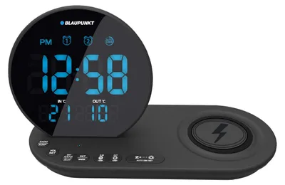 A black Blaupunkt digital alarm clock with a wireless charging pad.
