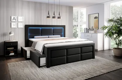 A modern bedroom with a black upholstered bed frame featuring LED lighting and storage drawers, a nightstand, and a dresser.