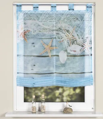 A window with a decorative curtain featuring a nautical theme.
