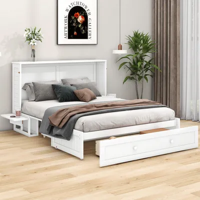 A white murphy bed with a mattress and bedding, a small side table, and an open drawer, set up in a bedroom.
