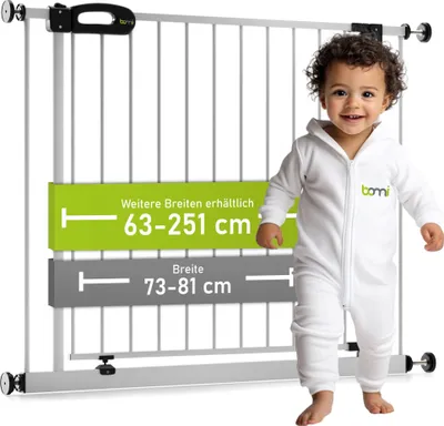 A baby in a white jumpsuit stands next to a white safety gate with measurement indicators.