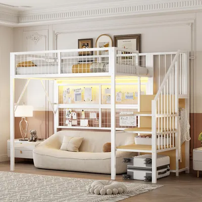 A bedroom scene featuring a white loft bed with stairs, a sofa underneath, and decorative elements.