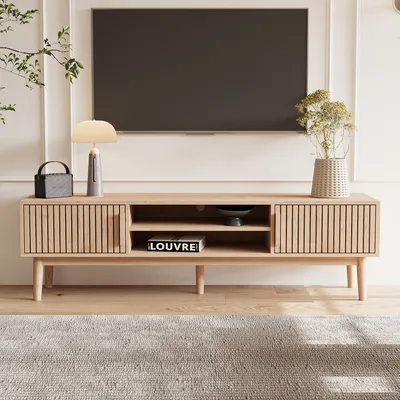 A modern living room scene featuring a TV stand with a television mounted above it.