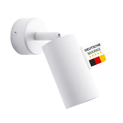 A white cylinder-shaped spotlight mounted on a white wall plate, with a German quality mark attached.