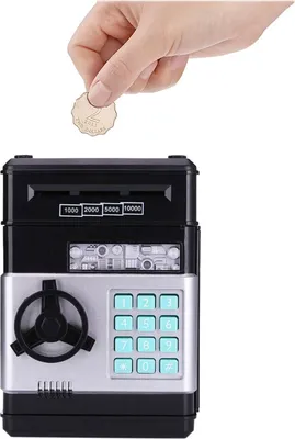 A hand is inserting a coin into a black and silver electronic piggy bank with a keypad and a dial.