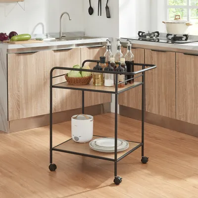 A kitchen scene with a rolling cart in the foreground and kitchen cabinets and a sink in the background.
