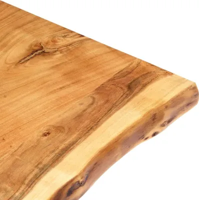 A close-up view of the edge of a wooden tabletop with a live edge.