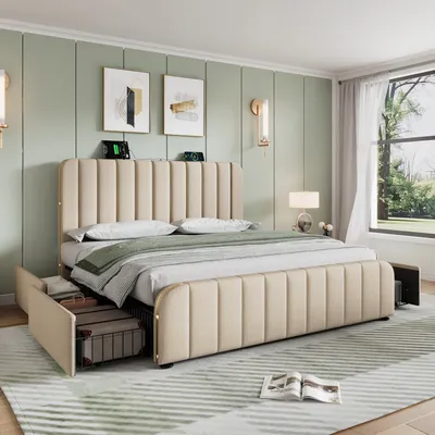 A bedroom scene featuring a beige upholstered bed with storage drawers, bedside tables, and wall art.