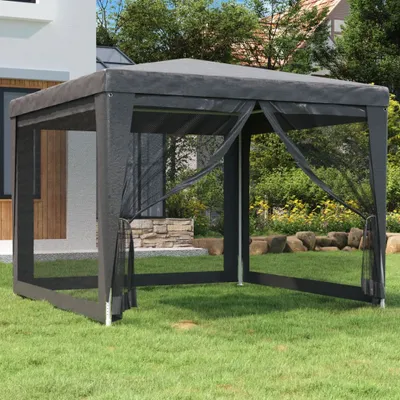 A dark gray gazebo with mesh sides is set up on a green lawn in a backyard. Trees and a house are visible in the background.
