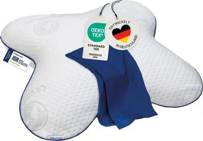 A white orthopedic pillow with blue trim and a blue cover, featuring several tags attached.