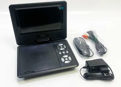A portable DVD player and its accessories are laid out on a white surface.