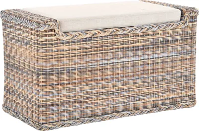 A woven storage bench with a cushion on top.