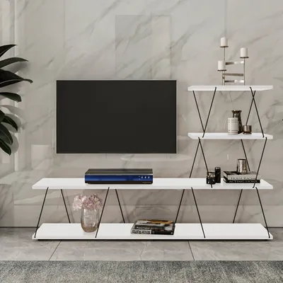 A modern white TV stand with a wall-mounted TV and decorative items.