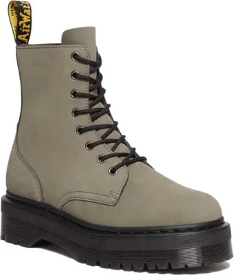 A single gray Dr. Martens boot with a black platform sole and black laces is shown against a white background.