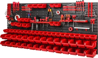 A wall-mounted tool organizer with many red storage bins and various tools displayed.