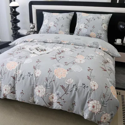 A neatly made bed with floral patterned bedding.