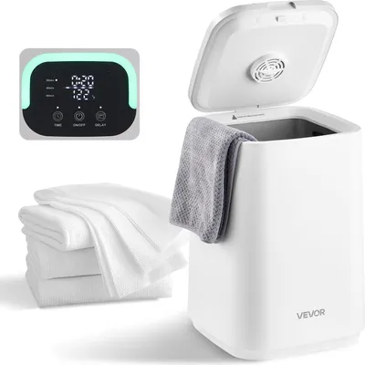 A white towel warmer bucket with a gray towel draped over the side, a stack of white towels next to it, and a digital control panel in the upper left corner.