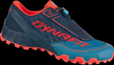 A single Dynafit trail running shoe against a black background.