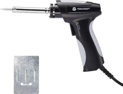 A soldering gun and a metal plate are shown against a white background.