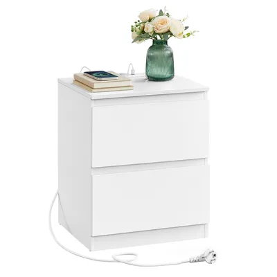 A white, two-drawer nightstand with a vase of flowers and a phone on top, with a power cord extending from the bottom.