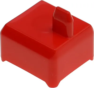 A red plastic component with a small lever or protrusion on top, isolated on a white background.