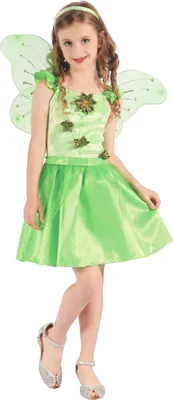 A young girl wearing a green fairy costume with wings, standing against a white background.