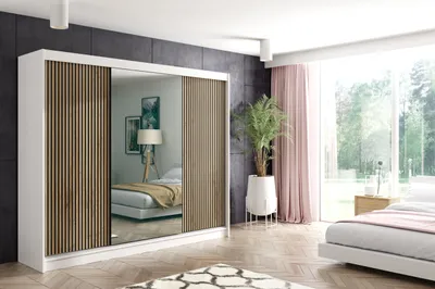 A bedroom scene with a large wardrobe, bed, and window.