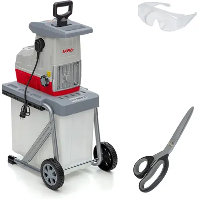 A garden shredder with a collection bin, safety glasses, and scissors, displayed against a white background.