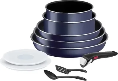 A set of blue cookware with a detachable handle and two kitchen utensils, along with two white plates, arranged on a white background.