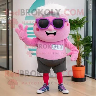 Immagine prodotto di Personaggio del costume della mascotte REDBROKOLY di Cupcake rosa vestito con un bermuda e occhiali da vista
